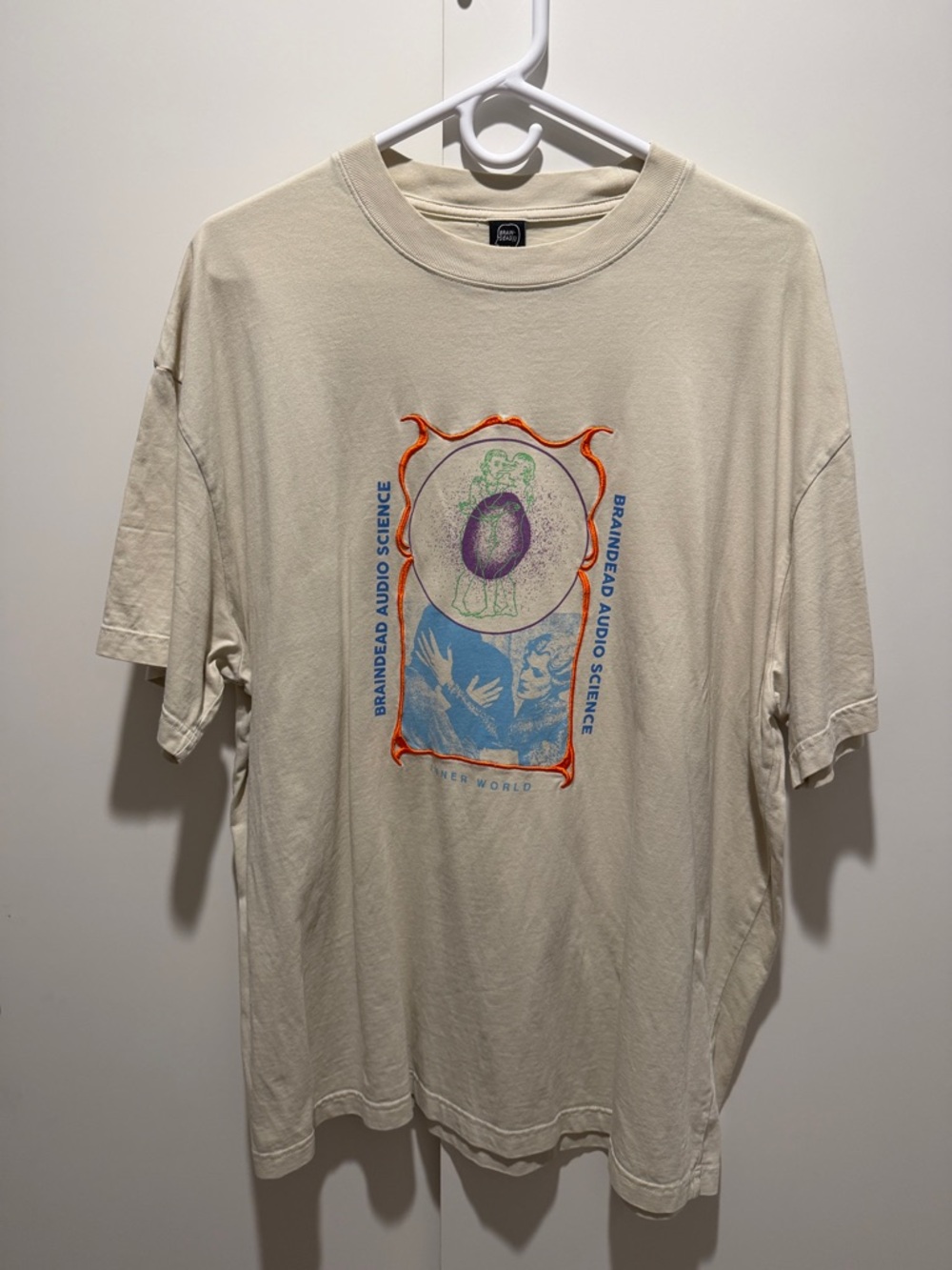Brain Dead Cream Graphic Short Sleeve Tee with Blue & Orange Print